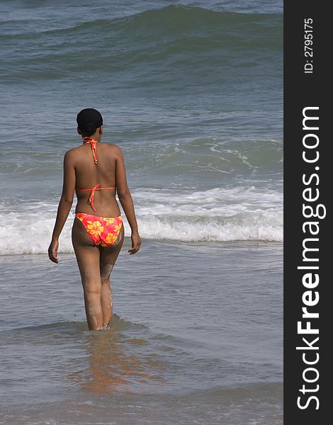 Pretty figured black woman going for a swim at the beach. Pretty figured black woman going for a swim at the beach