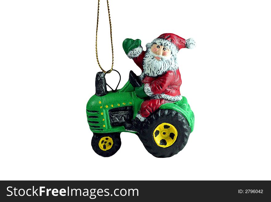 Santa on a tractor Christmas tree ornament that is isolated. Santa on a tractor Christmas tree ornament that is isolated.
