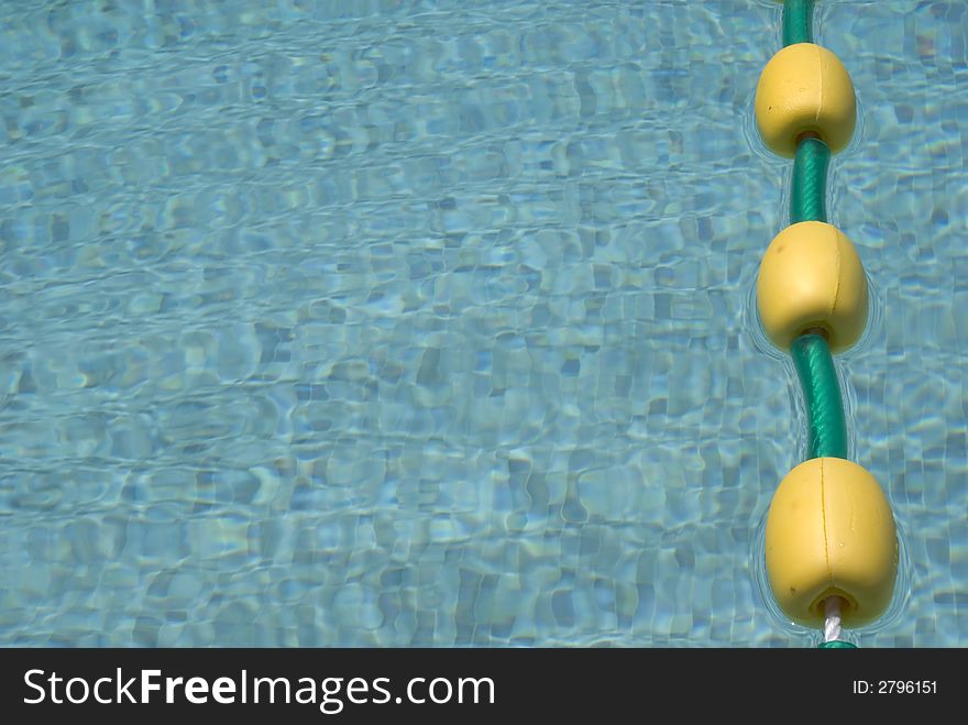 Close up of a pool with a line of yellow floats. Close up of a pool with a line of yellow floats