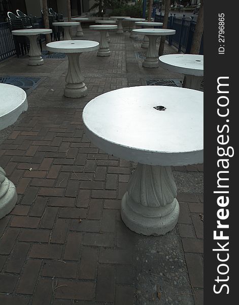 White patio tables at a pub, during off season.