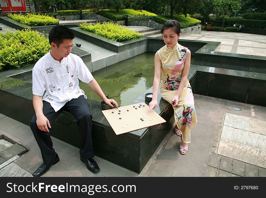 Asian young people play chess. Asian young people play chess