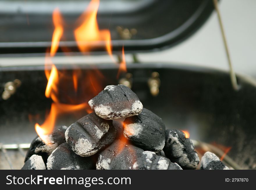 Closeup shot of charcoal briquettes burning in preparation to grill. Closeup shot of charcoal briquettes burning in preparation to grill