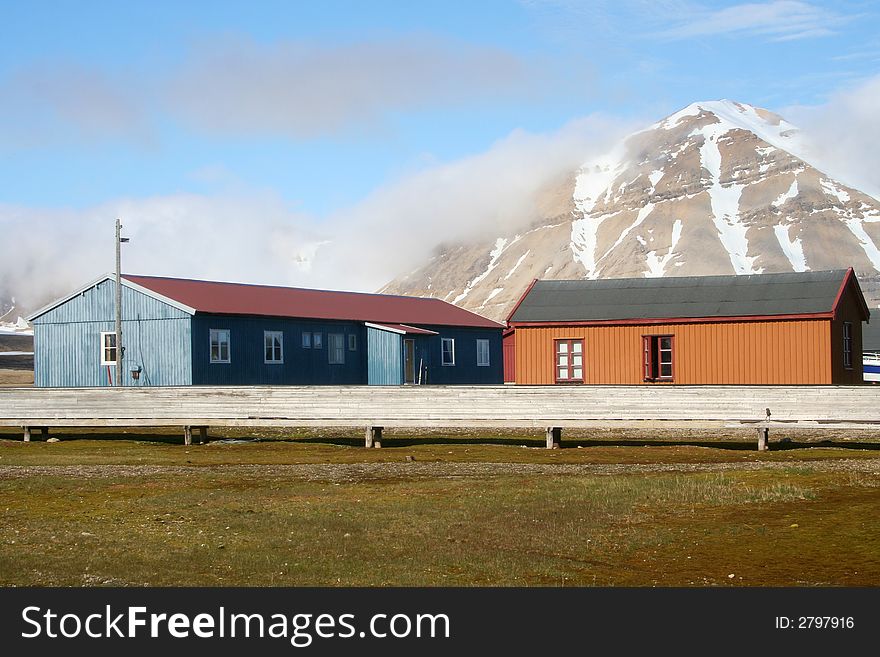 Two buildings set against a backdrop of a mountain. This part of the research center in Ny Alesund in the Svalbard region of the Arctic. Two buildings set against a backdrop of a mountain. This part of the research center in Ny Alesund in the Svalbard region of the Arctic