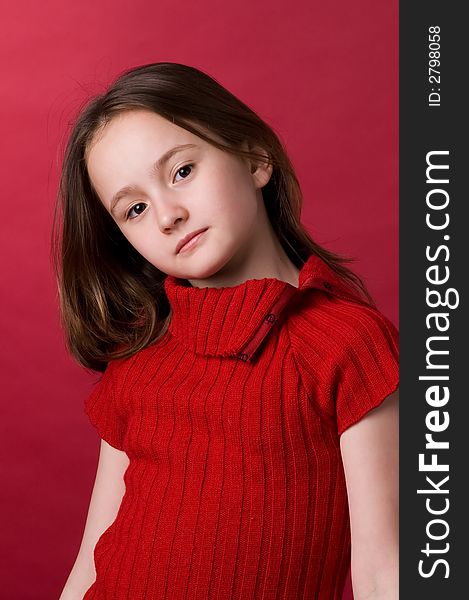 The girl of ten years in a red sweater in studio. The girl of ten years in a red sweater in studio
