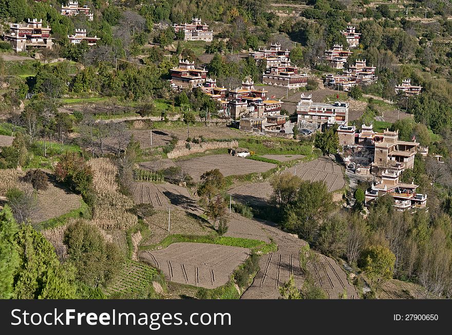 A Tibetan village located on a mountain slope. A Tibetan village located on a mountain slope