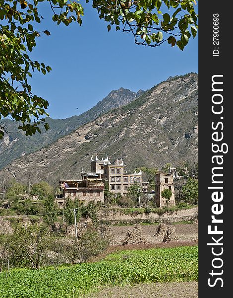 A Tibetan folk house surrounded by trees and fields