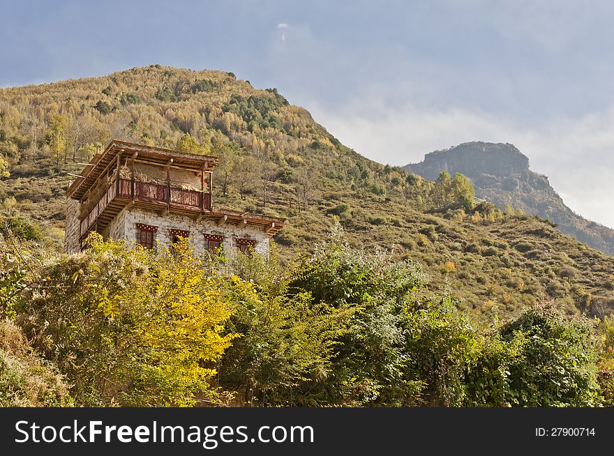A tibetan folk house on a hillside