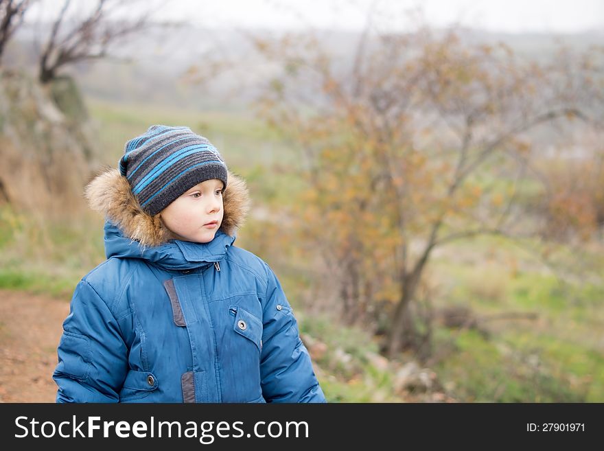 A young boy enjoying the surroundings around him in winters. A young boy enjoying the surroundings around him in winters.