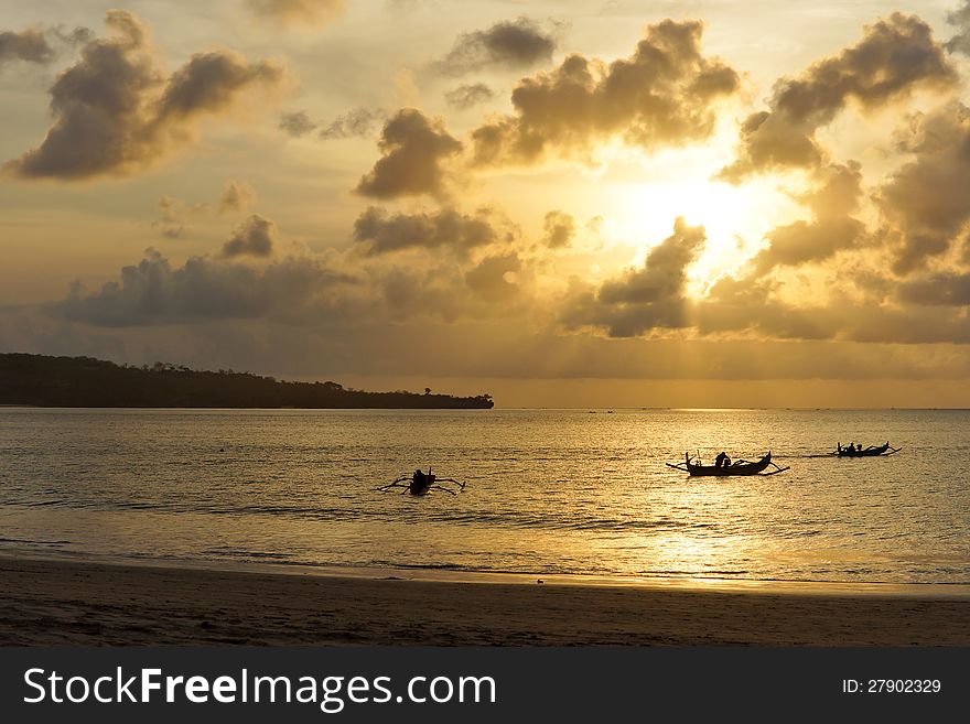 Three Outrigger Canoes At Sunset