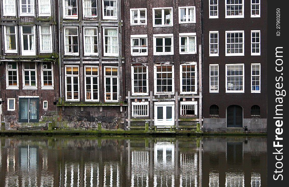 Symmetrical windows from a building in Amsterdam, Holland, Netherlands. Symmetrical windows from a building in Amsterdam, Holland, Netherlands.