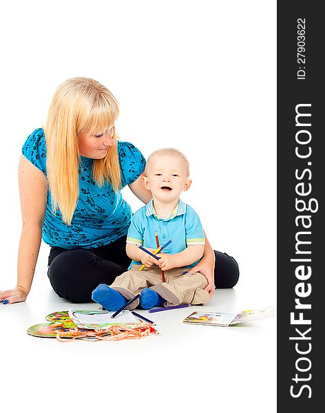 Mother with a child playing with pencils and paint. Mother with a child playing with pencils and paint