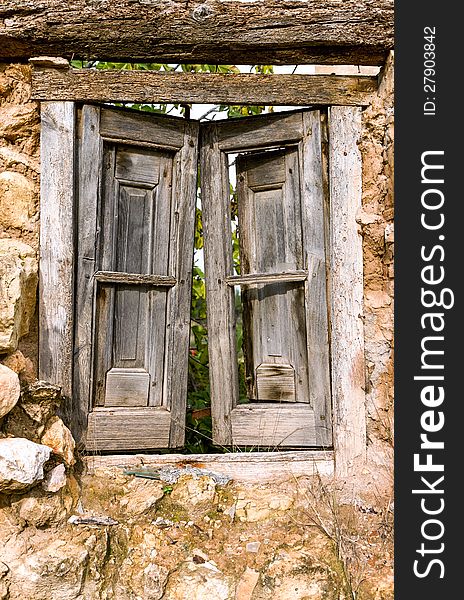 Old ruined closed wooden window