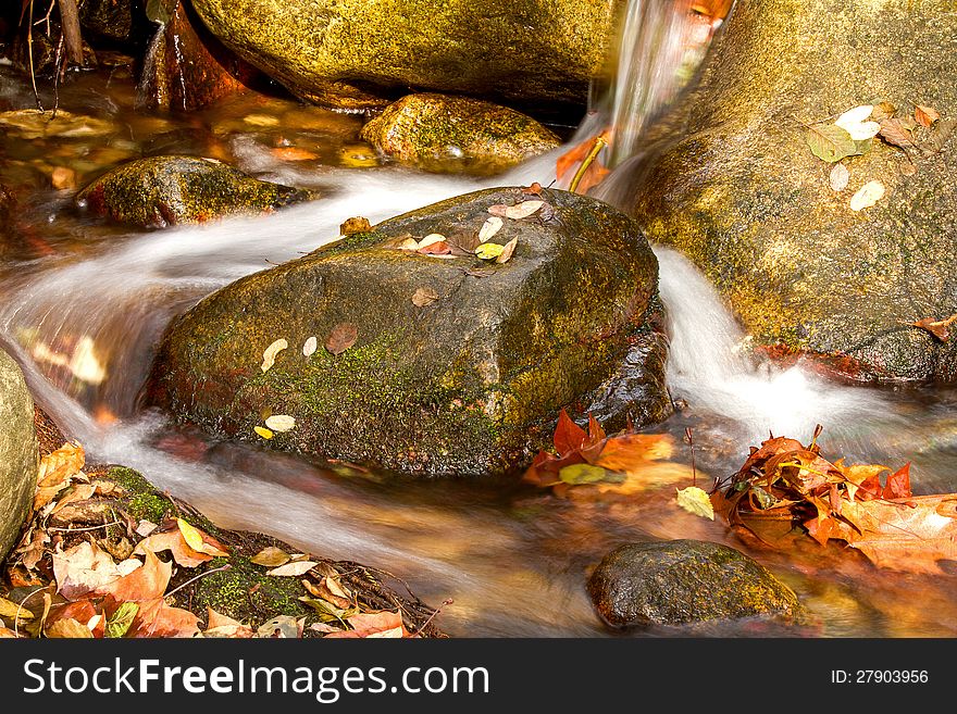 Beautiful veil cascading waterfall, mossy rocks