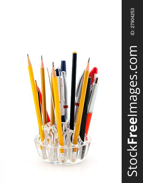 Glass holder for pencils and pens photographed against a white background