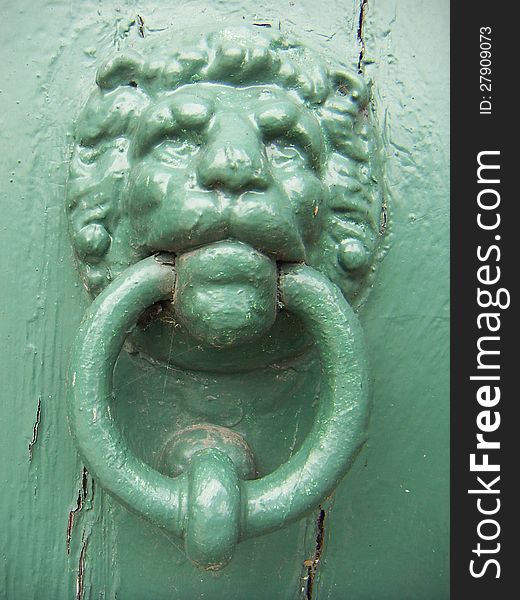 Green painted lion head door knocker