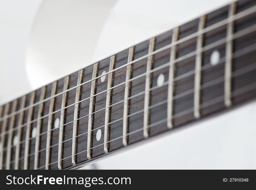 Electric guitar fingerboard with dot inlay and a pick