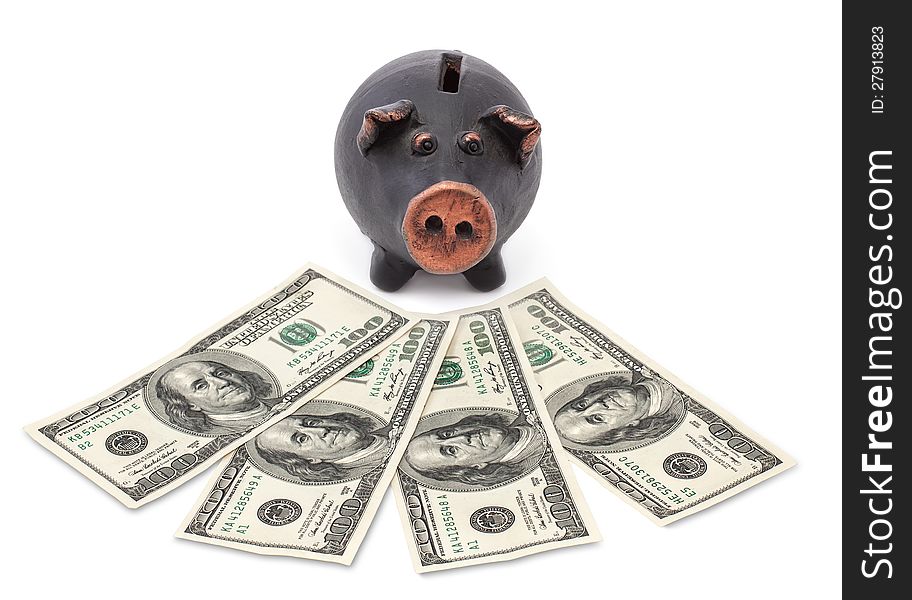 Money and black piggy bank on white background.