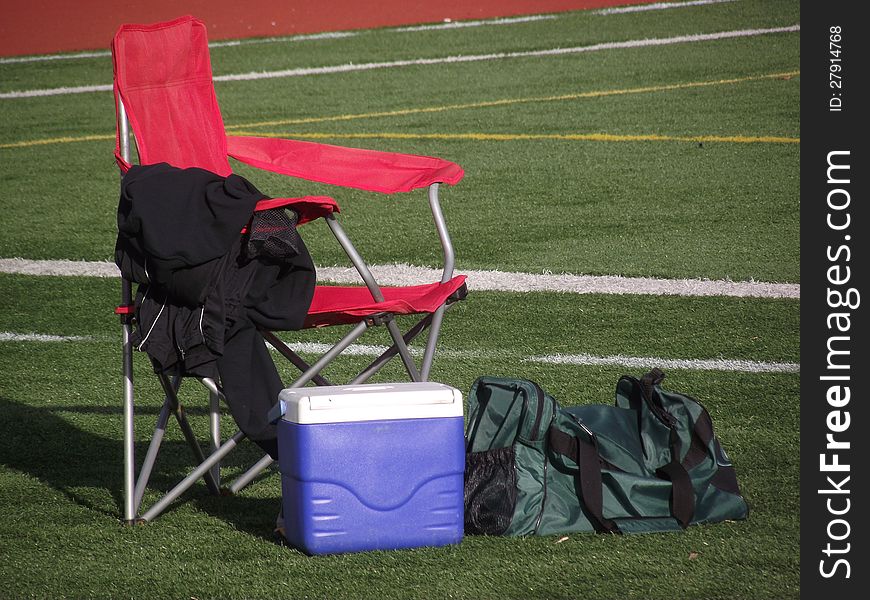 Chair And Athletic Gear On Football Field