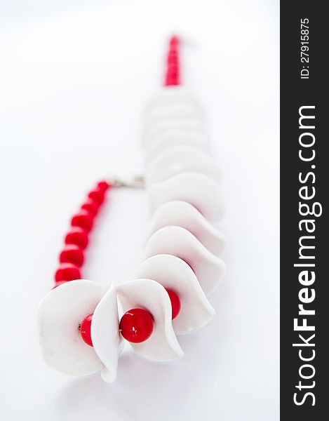 White and red necklace on a white background