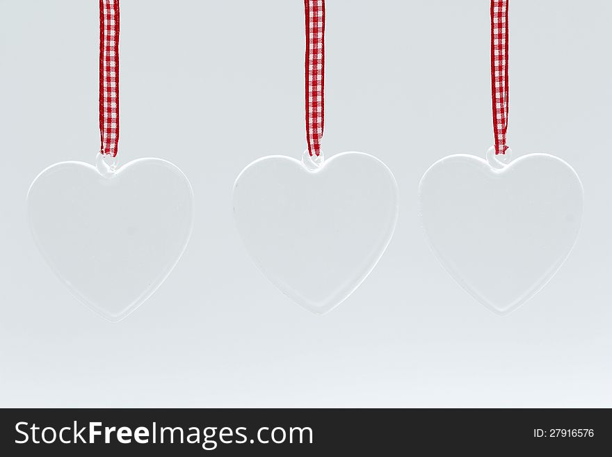 Glass hearts on white background