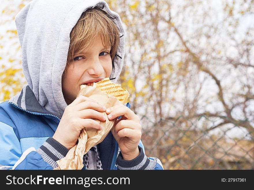 Boy eating sandwich-fast food