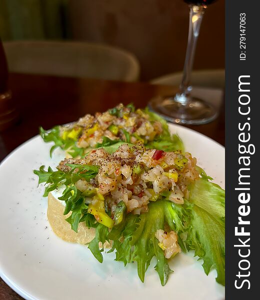 Two Sandwiches With Salad And Meat On A Round White Plate