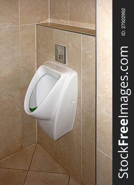 White urinal in a public toilet for men