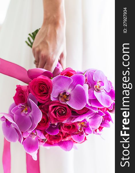 The bridal bouquet consist out of purple orchads and pink roses. The bridal bouquet consist out of purple orchads and pink roses.