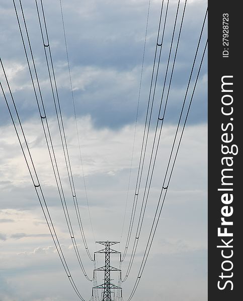 The electricity post and an electric line and back rucksack sky ground