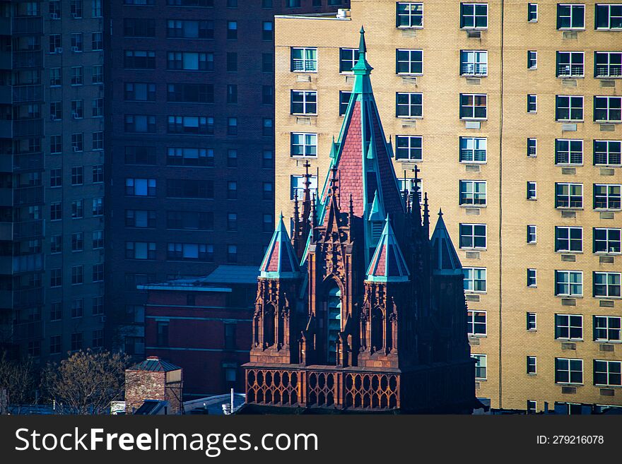 Jagged Church Spires Rise Sharply, Cutting Across The Urban Housing Background Of Manhattan& X27 S Upper East Side Neighborhood. T