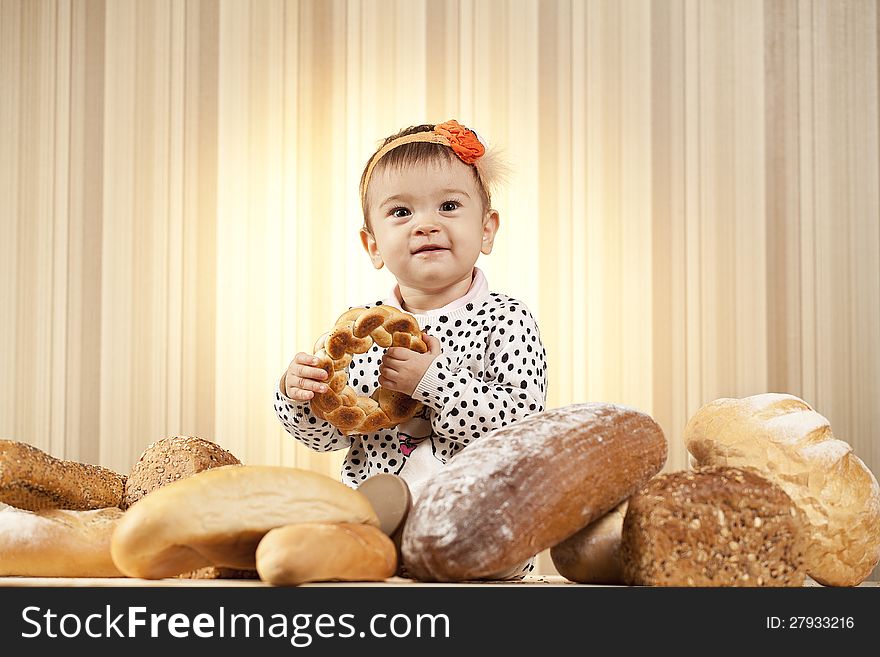 White infant choosing bread in studio. White infant choosing bread in studio