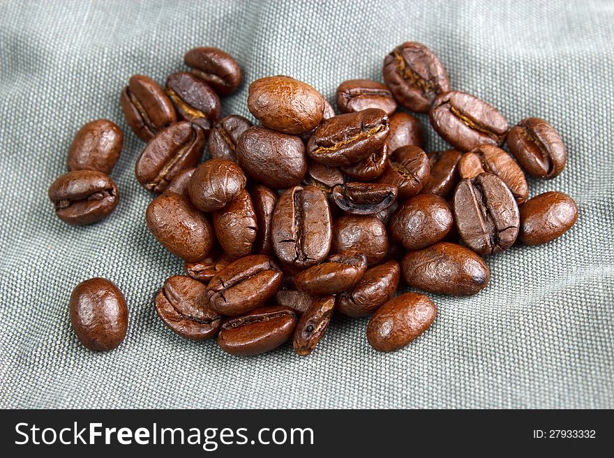 Coffee beans on fabric background