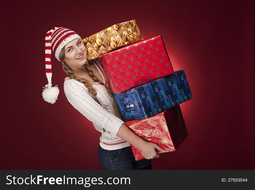 Studio shoot of woman with Santa hat  with presents isolated. Studio shoot of woman with Santa hat  with presents isolated