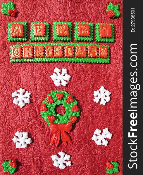 Handmade christmas card with holly wreath and snowflakes