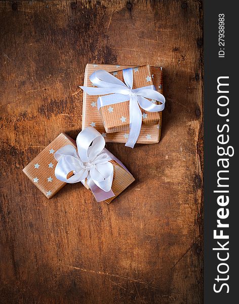 Christmas boxes with White Ribbon on a Wooden Surface. Christmas boxes with White Ribbon on a Wooden Surface