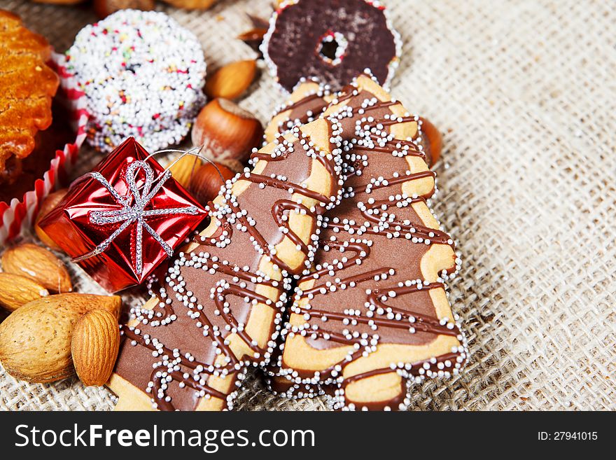 Cookies made in shape of a Christmas tree, nuts and other pastry. Cookies made in shape of a Christmas tree, nuts and other pastry