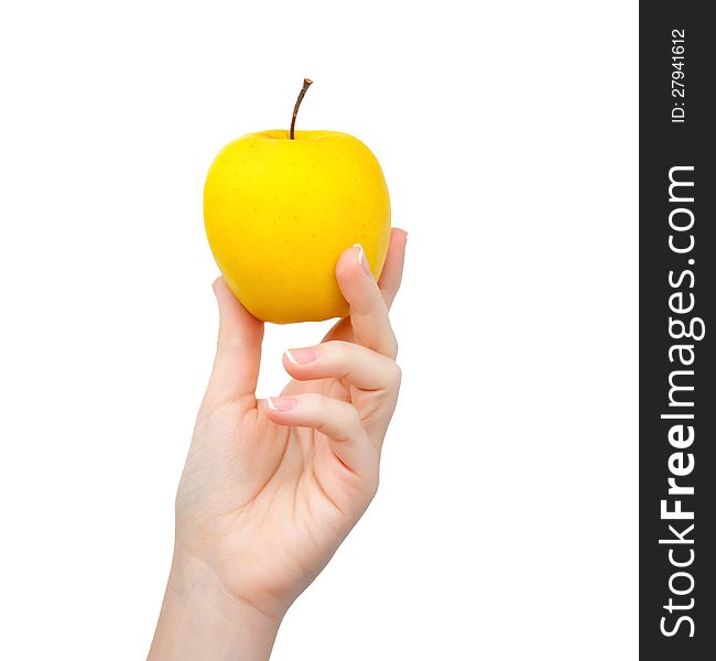 Woman hand on isolated background holding a yellow apple. Woman hand on isolated background holding a yellow apple