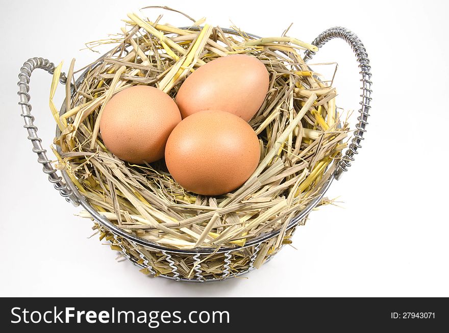 Nest with eggs in basket on white background