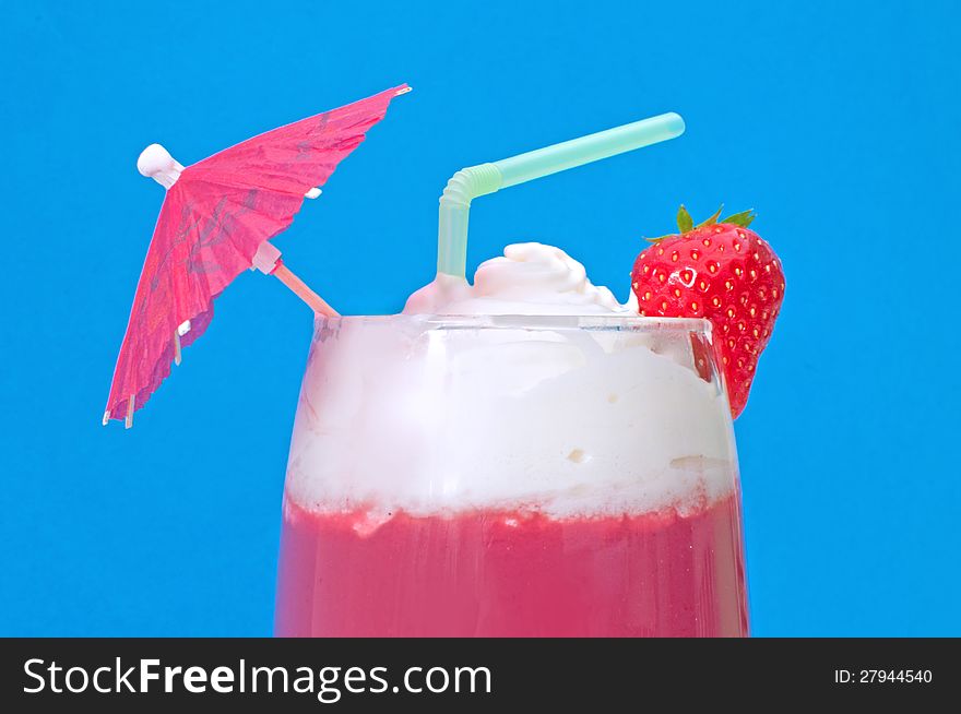 Close up of a cocktail drink with umbrella and straw