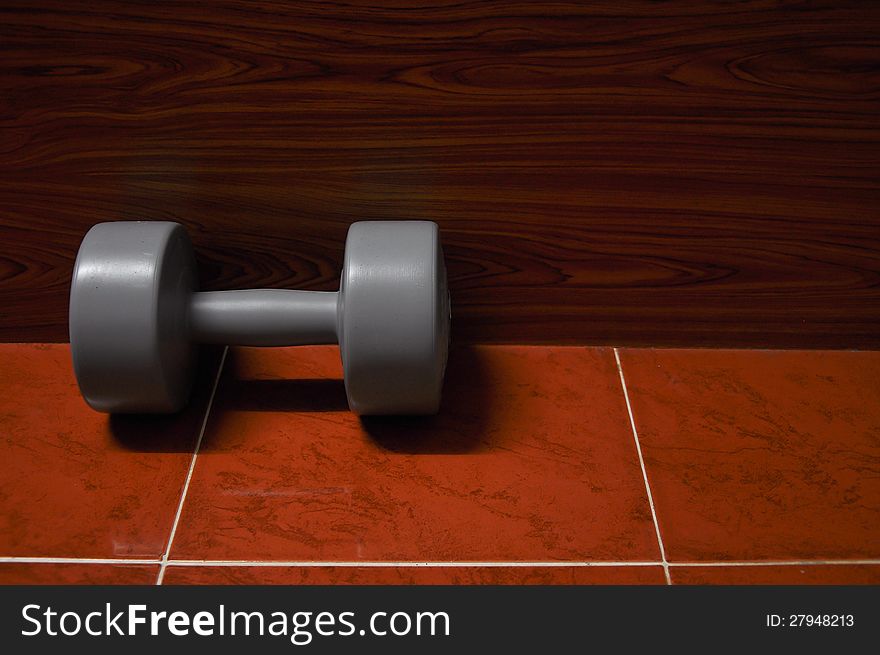 Lonely dumbbell on the floor. Lonely dumbbell on the floor