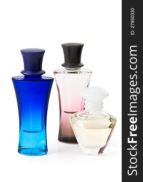 Three bottles of perfume are photographed on the white background
