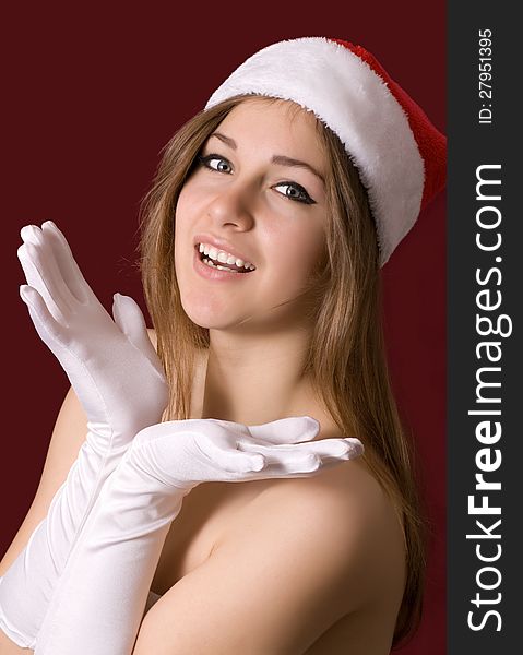 Young happy girl in Christmas hat.