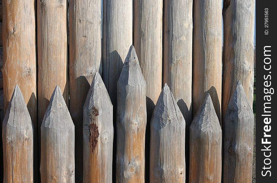 Wooden paling from the sharp raw logs