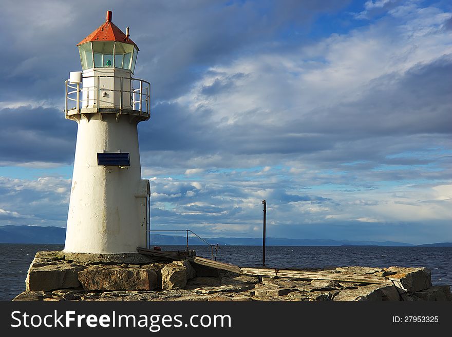 Small lighthouse on rocks in Trondheim Norway