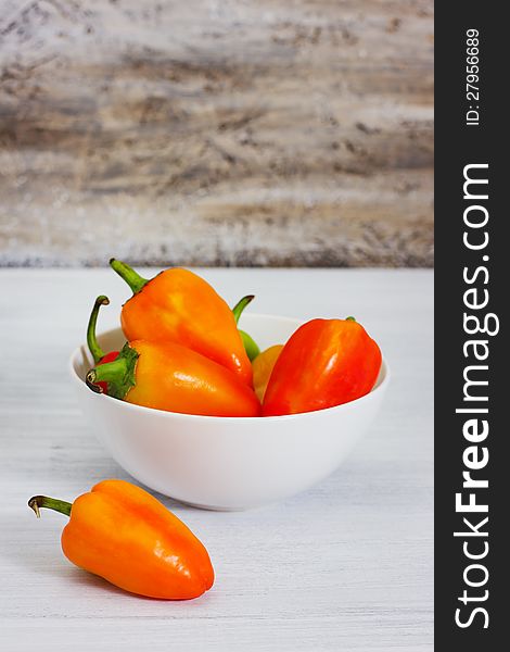 Group of ripe fresh peppers, on rusty wood background, selective focus