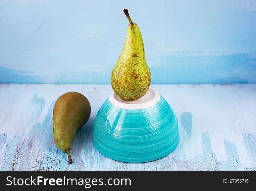 Two fresh juicy Conference Pears with blue background. Two fresh juicy Conference Pears with blue background