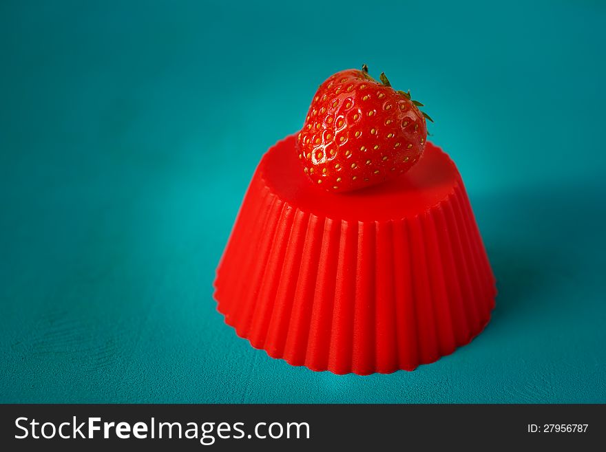 Red strawberry berry on red stand. Red strawberry berry on red stand