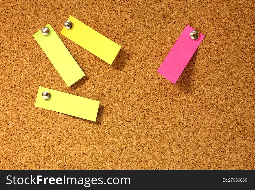 Post-it notes pushpins on cork board. Post-it notes pushpins on cork board.