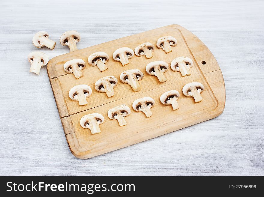 Mushrooms (champignons) on cutting board. Mushrooms (champignons) on cutting board