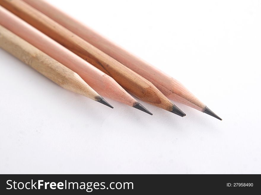 Four plain wooden pencils, on white background, soft shadow. Four plain wooden pencils, on white background, soft shadow